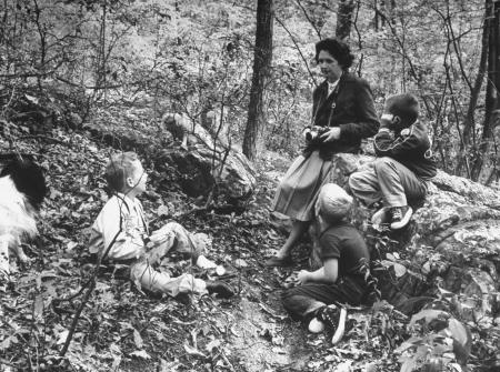 Photo of Rachel Carson talking with children in the woods